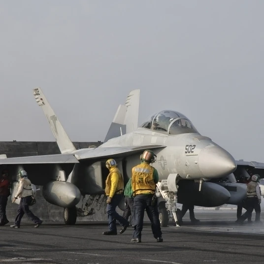 An EA-18G Growler is guided into catapult aboard USS George H.W. Bush Poster Print (38 x 20) | Дом и сад