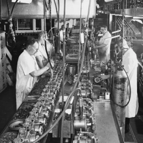 Workers assembling the motor and pump of a household refrigerator unit Poster Print (18 x 24) | Дом и сад