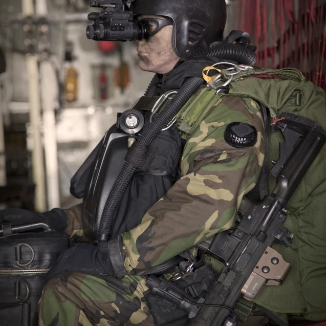 U.S. Navy Seal equipped with night vision prepares for HALO jump ...