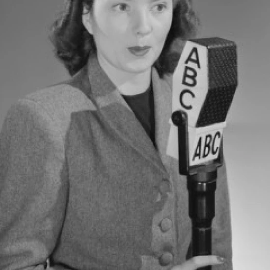 Studio portrait of female reporter speaking into microphone Poster Print (24 x 36) | Дом и сад
