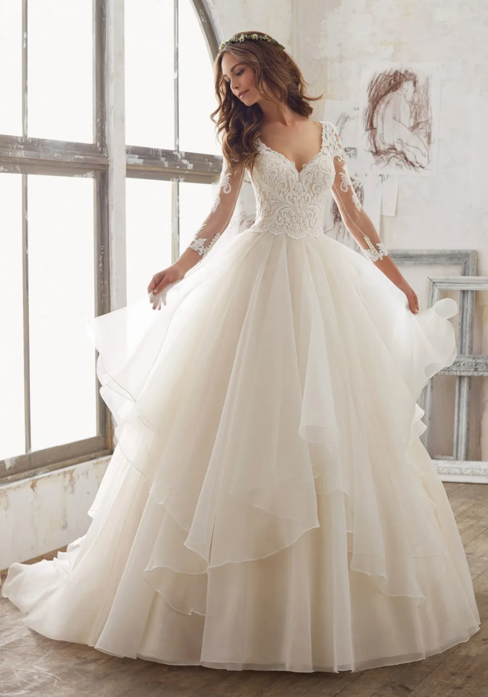 Wedding dress with long sleeves and ruffle bottom