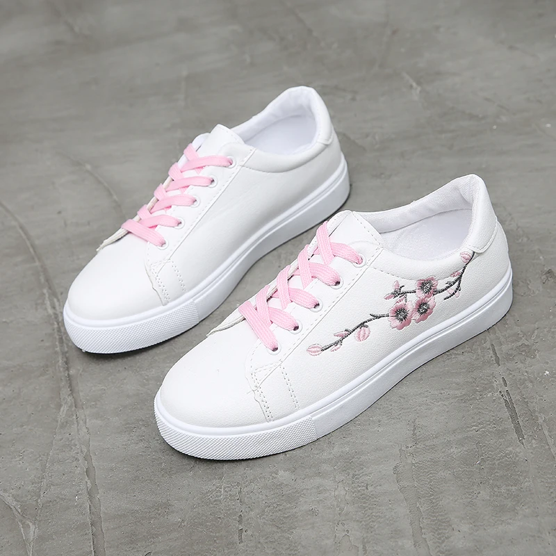 white sneakers with flowers on them
