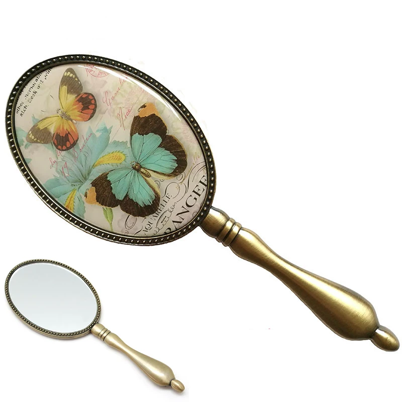 

European Vintage Antique Brass Oval 3x4 inches Metal Alloy Framed Glass Hand Mirror with Butterfly Epoxy Decor Back