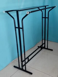 Clothing store display shelf. Console, wrought iron clothes frame. The parallel bars hangers.