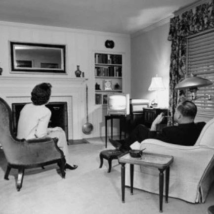 Rear view of a mature adult couple watching television Poster Print (18 x 24)