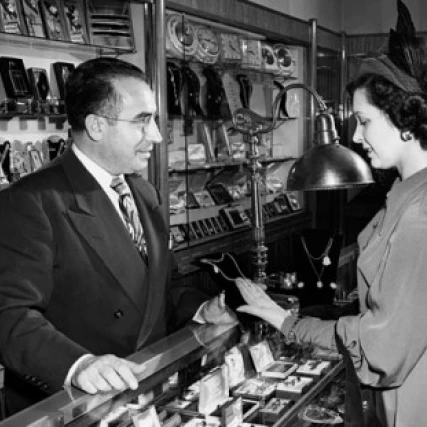 Mid adult woman buying jewelry in a jewelry store Poster Print (18 x 24)