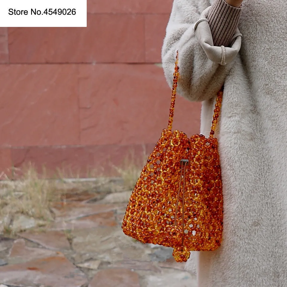 

Acrylic Amber Pearl Tote Braided Bead Bucket Bag Handmade Drawstring Small Hollow Handbags LadY Party Evening Bags INS Designer