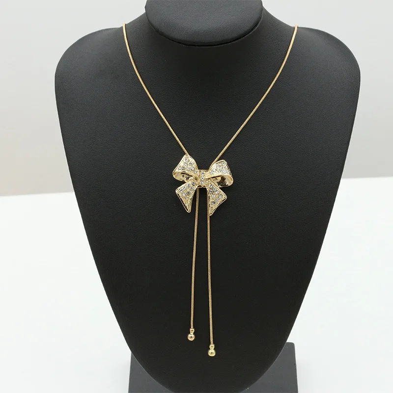 

Korean version of the new bow pendant necklace Exquisite alloy with rhinestone sweater chain Girls banquet gifts Free postage