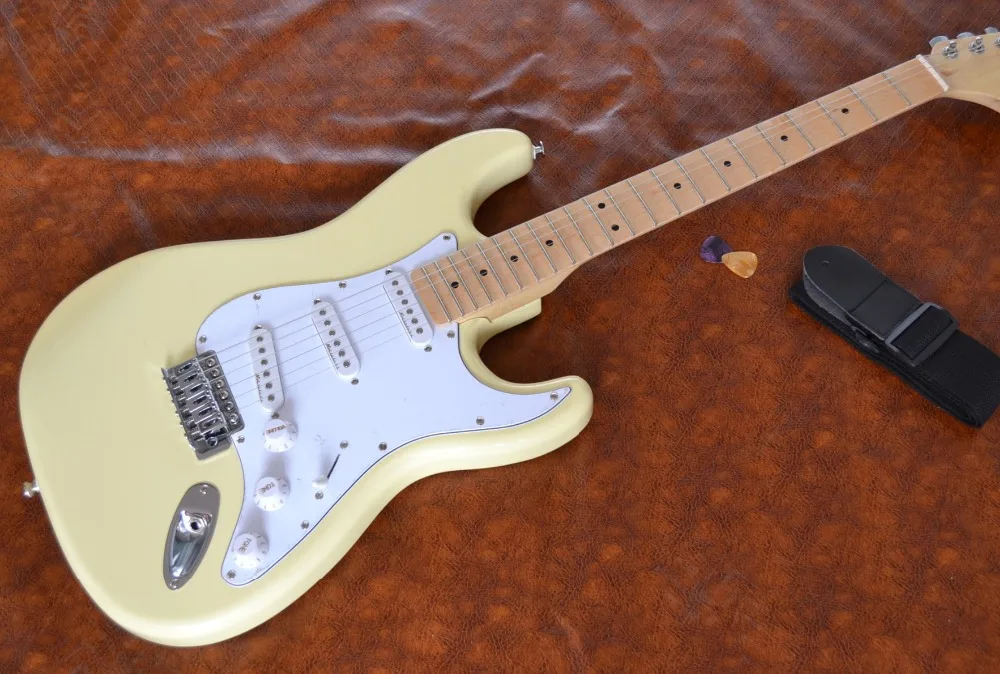 

Grooved finger plate electric guitar, cream yellow, three single pickup, support customization, welcome to buy