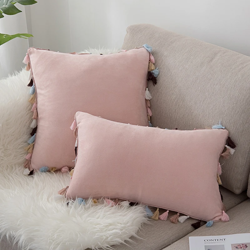 pink pillow with tassels