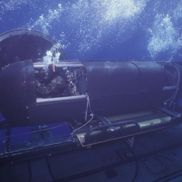 A SEAL Delivery Vehicle navigates onto the Dry Deck Shelter on USS Kamehameha Poster Print (34 x 22)