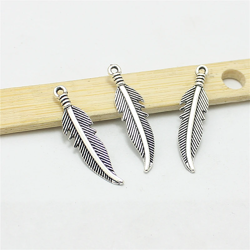 

Sweet Bell 100pcs 7*27mm Antique Zinc Alloy Feathers Charms Diy Jewelry Findings Jewelry Accessories wholesale D1171