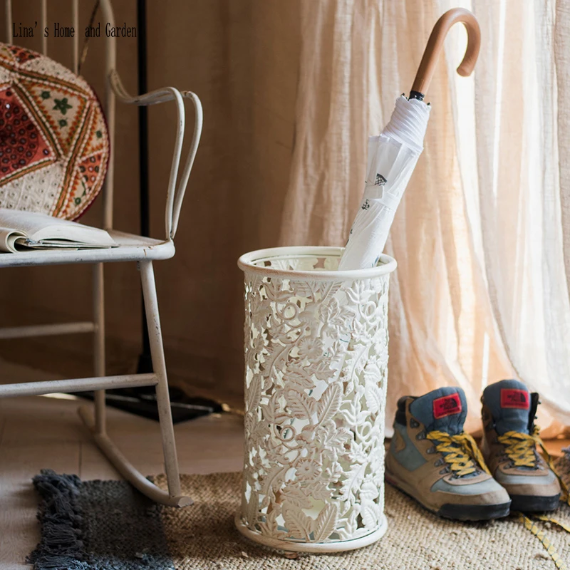 

indoor handcrafted piered vintage white metal walking stick and umbrella stand