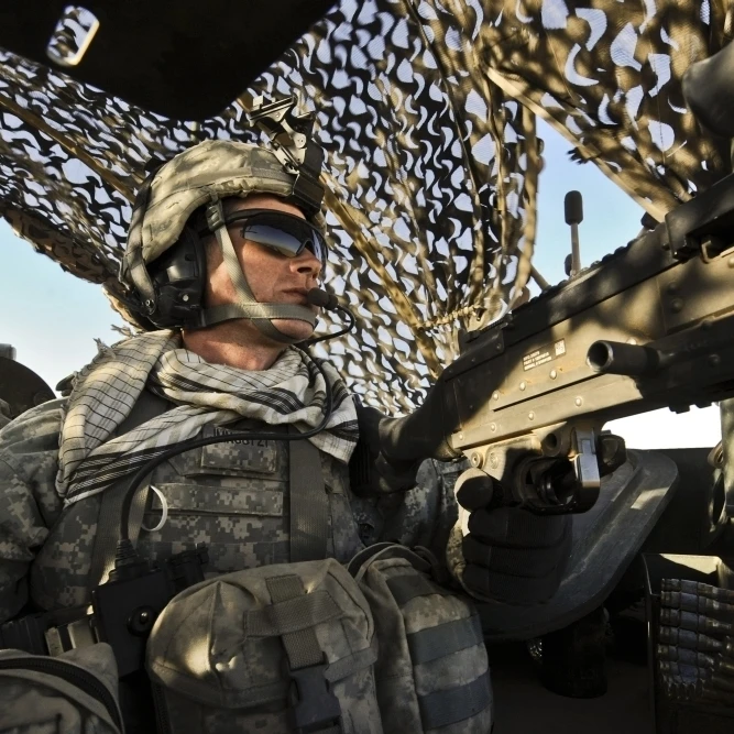 U.S. Army Specialist provides rear security inside a Stryker armored vehicle Poster Print (34 x 22)