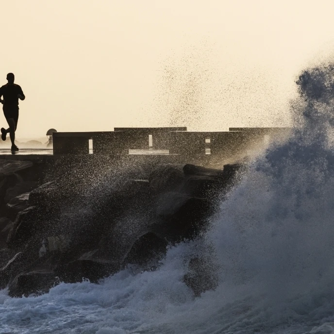 Silhouette of a man running along the coast; La Isla  Tarifa  Cadiz  Andalusia  Spain Poster Print (36 x 24)