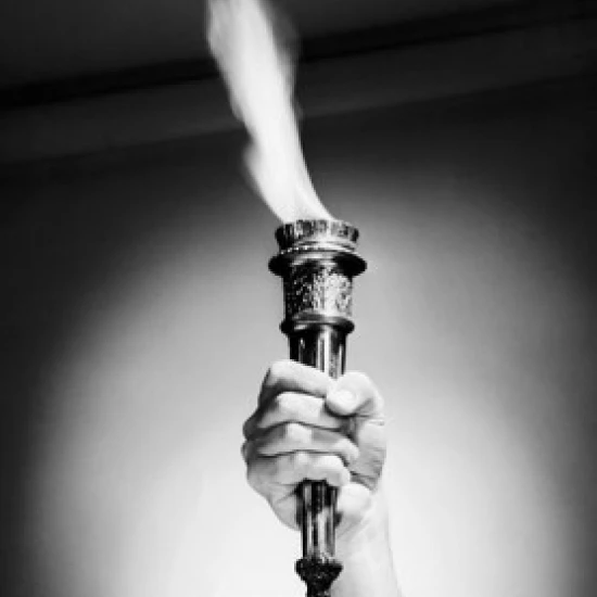 Close-up of a person's hand holding a flaming torch Poster Print (18 x 24)