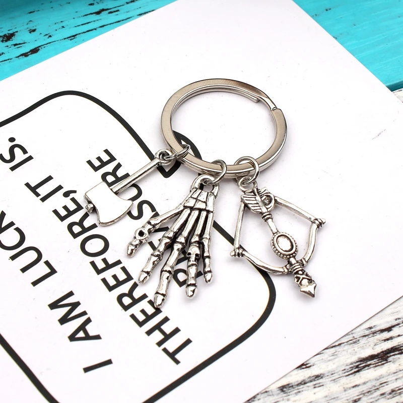 

New Fashion KeychainThe Walking Dead Pendants DIY Men Jewelry Car Key Chain Ring Holder Souvenir For Gift bow ax Bone hand