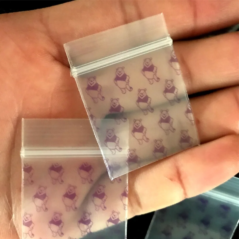 

1 pack (100 pcs)cartoon new tobacco bag sealed bag storage bag Transparent purple bear pattern with holder tobacco bag