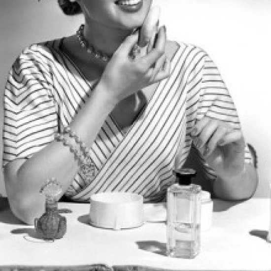 Portrait of beautiful woman applying make-up Poster Print (18 x 24)