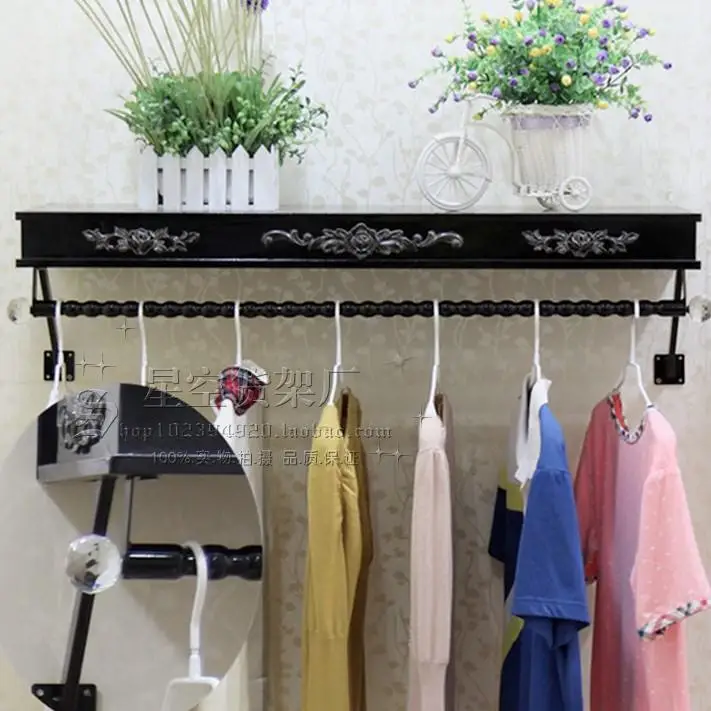 Clothes hangers show. On the wall clothing. Clothing store shelves of carve patterns or designs on woodwork hanging.