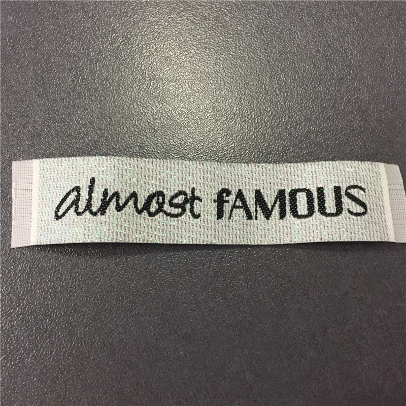 

Custom 1.8*8.2cm High Density Mosaic Gold background with black Letters Woven Label Laundry Labels For Clothing