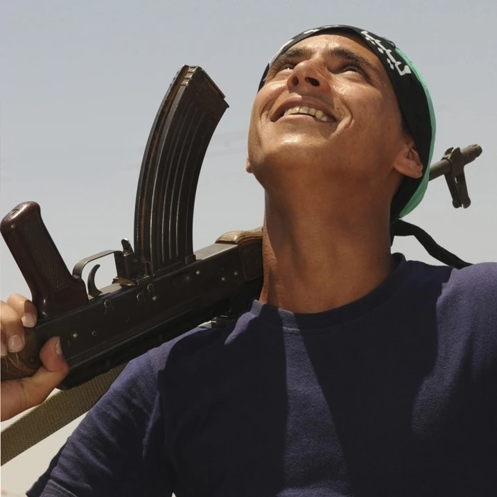 A rebel fighter with an AK-47 assault rifle mans a checkpoint in Ajadabiya  Libya Poster Print (16 x 12)