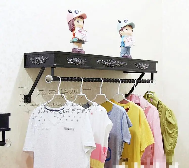 Clothes hangers show. On the wall clothing. Clothing store shelves of carve patterns or designs on woodwork hanging.