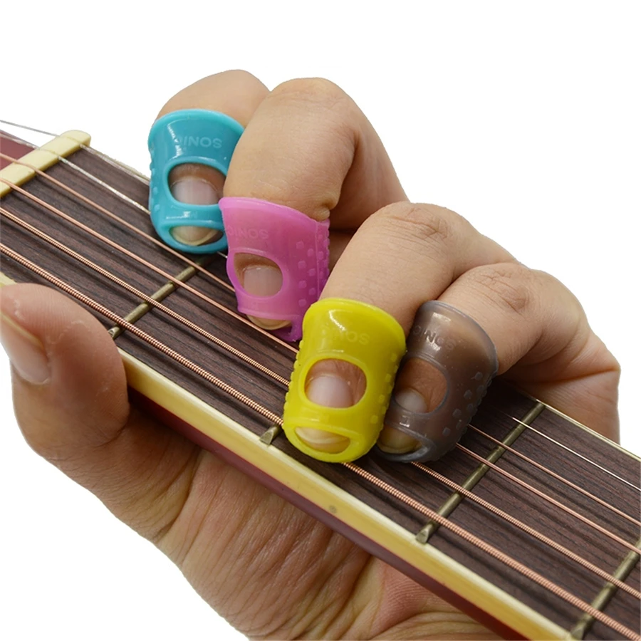 

4 pcs/lot Silicone Guitar Fingertip Finger Thumb Picks Plectrums Sheath for Practice for most fingers Random Color