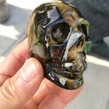 

The hand-carved skull of a natural blue tiger eye stone is used as a home decoration