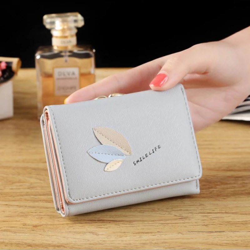 

New-style simple leaf Korean leisure student zero purse button three fold card lady wallet girl short hand to take.