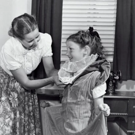 Mother making a dress for her daughter Poster Print (18 x 24)