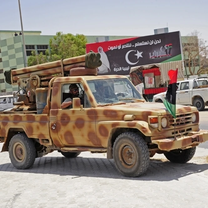 A Free Libyan Army pickup truck equipped with a homemade rocket Poster Print (34 x 22)