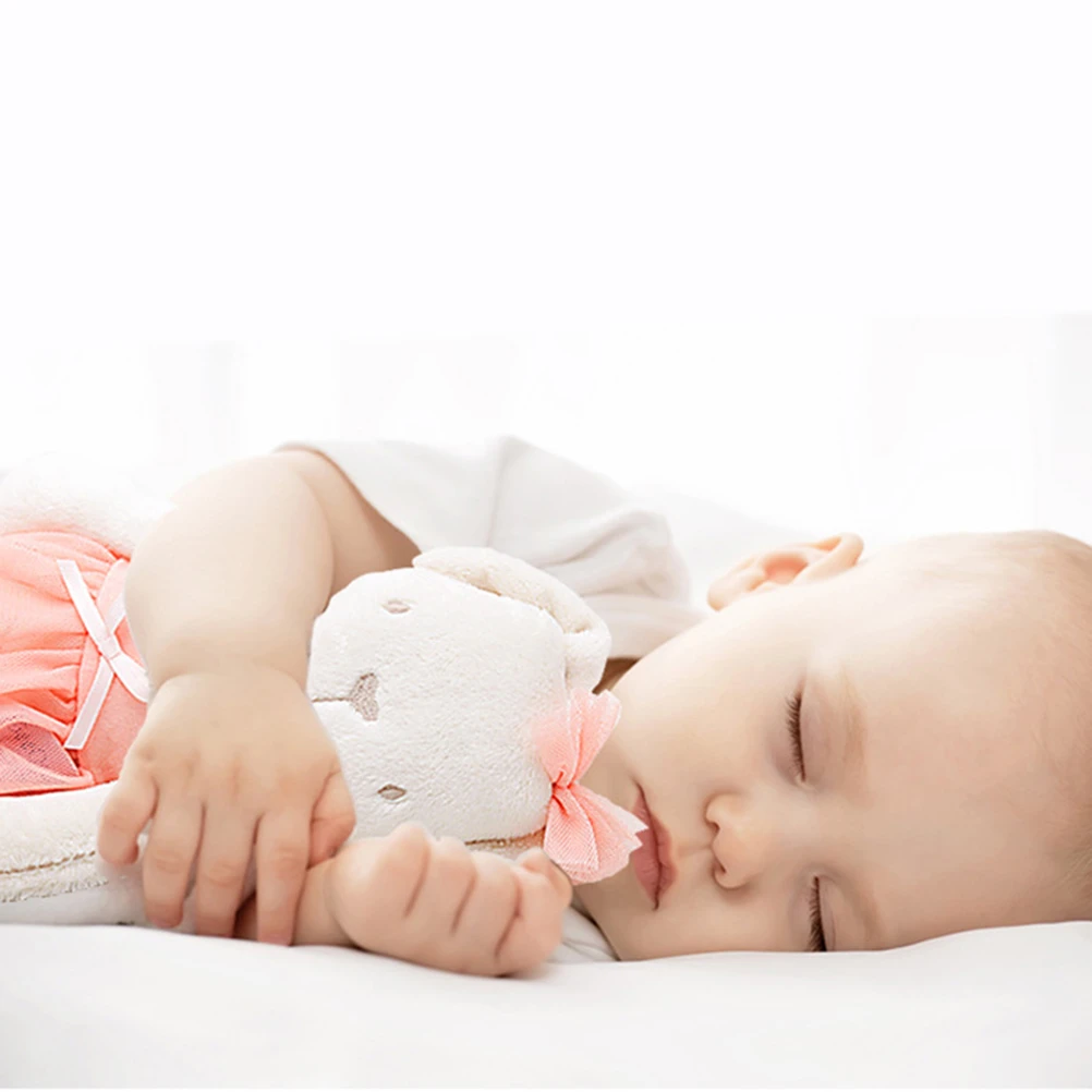 baby sleeping with stuffed animal