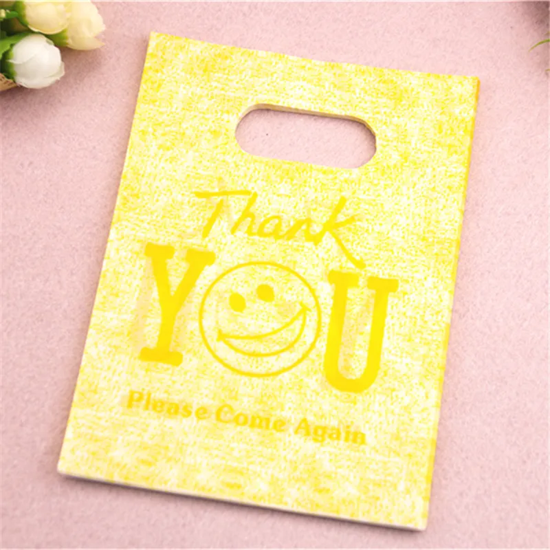 PROD 32828396357 New Design Wholesale 100pcs/lot 13*18cm Yellow Plastic
Gift Packaging Bags With Thank You Letter Smile Face Shopping Bags