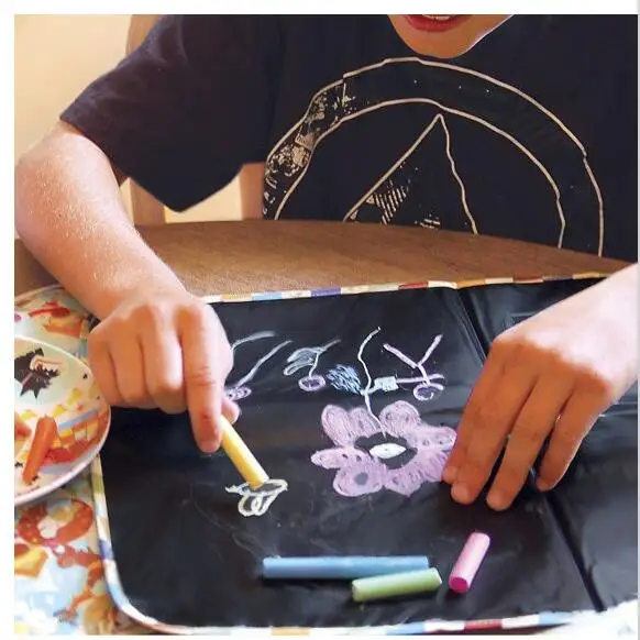 

Children painting soft black board mats can be folded out of the travel home can be painted with chalk