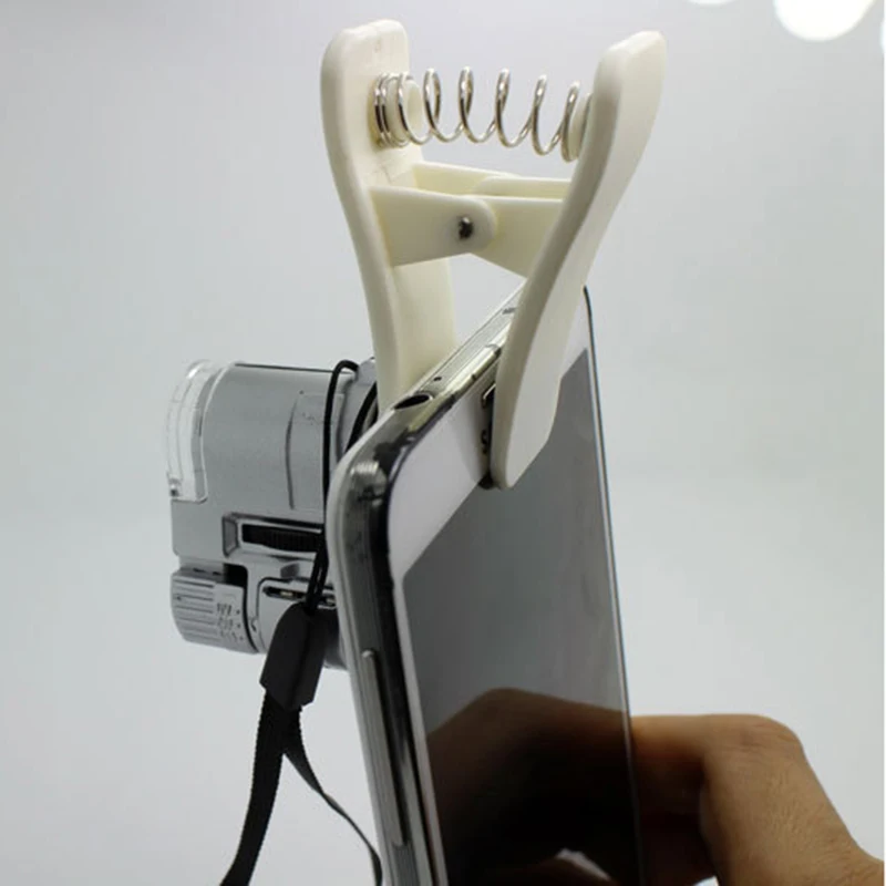 

1Pcs Universal 63x Zoom LED UV Light Mini Microscope Micro Mobile Phone Lens Clip for Samsung Galaxy S5 s6 s7 for iPhone 5s 6s 7