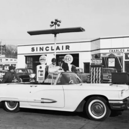 Man refueling a car at a gas station Poster Print (24 x 36)