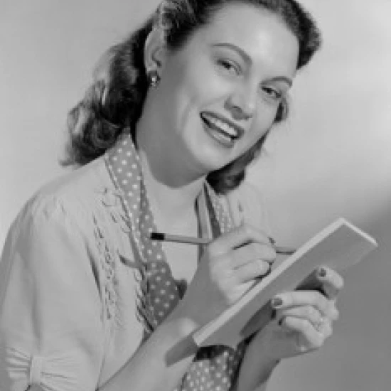 Portrait of smiling housewife with shopping list Poster Print (24 x 36)