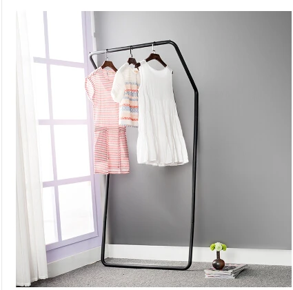 Display stand. Colorful floor against the wall. Hanger. Clothing. Clothes tree.