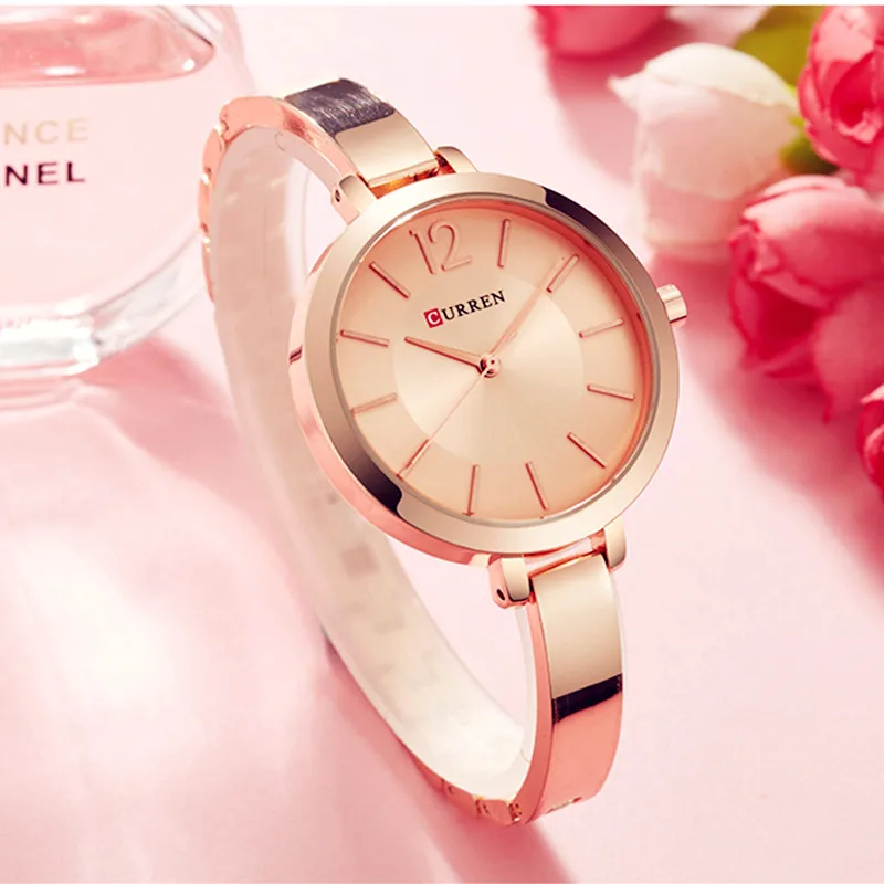 An Ultra Thin Romantic Clock women's watch on a pink background, exuding a romantic charm.