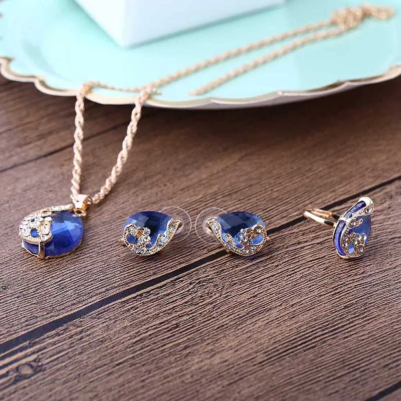 

Wholesale Gold Color Austrian Peacock Three-piece Crystal Zircon Water Drop Pendant Necklace Earring Ring Set Female Bijouterie
