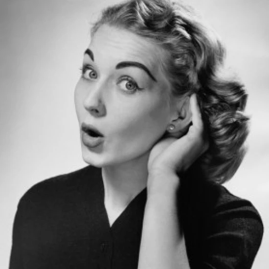 Portrait of a young woman cupping her ear to hear Poster Print (24 x 36)