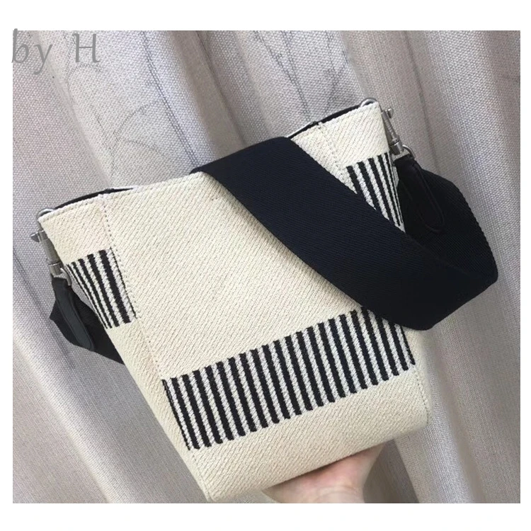 

by H 2019 new womens big bucket bag wide guitar strap piano key white black canvas shoulder bag vacation vibes chic handbag