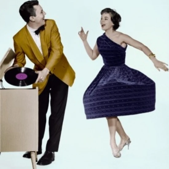 Young man holding record looking at young woman dancing Poster Print (24 x 36)