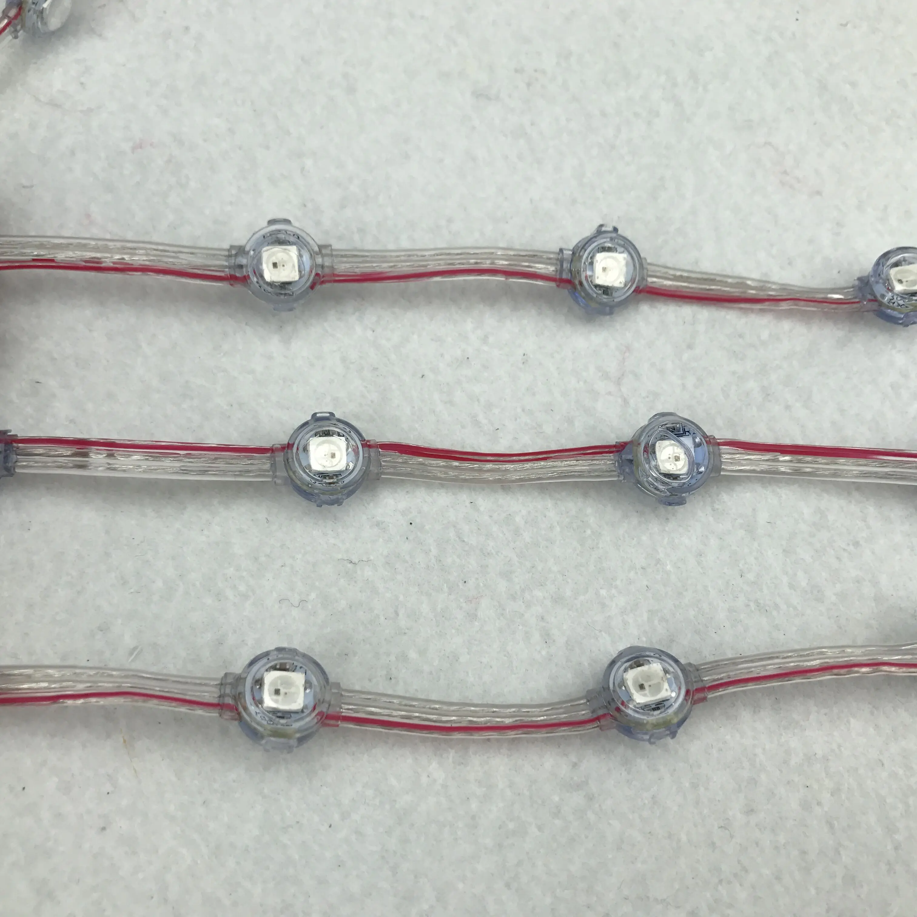 

10mm/8mm/5mm/4mm pitch IP68 rated RGB addressable;WS2812B 12V pixel module;40pcs a string;clear wire