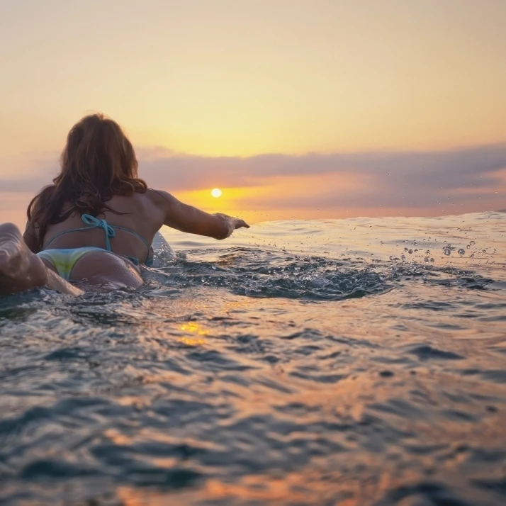 A Woman Laying On A Surfboard Watching The Sunset; Tarifa  Cadiz  Andalusia  Spain Poster Print (36 x 26)