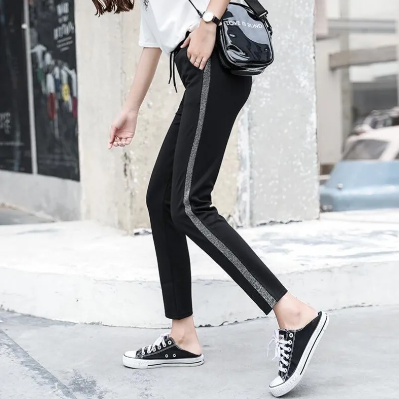 

Spring and autumn new Korean fashion side Silver thread striped stitching casual pants female loose large size harem pants tide