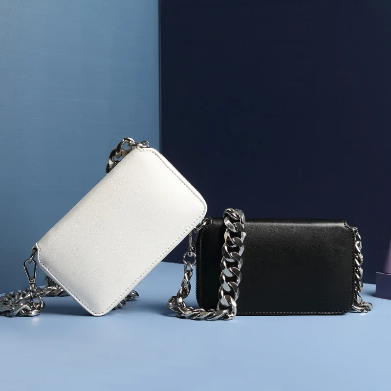 

Real , thick chain, small , one shoulder slant.
