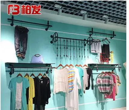 

The wall hangers of iron arts clothing store have a vintage display rack of men's and women's clothes racks