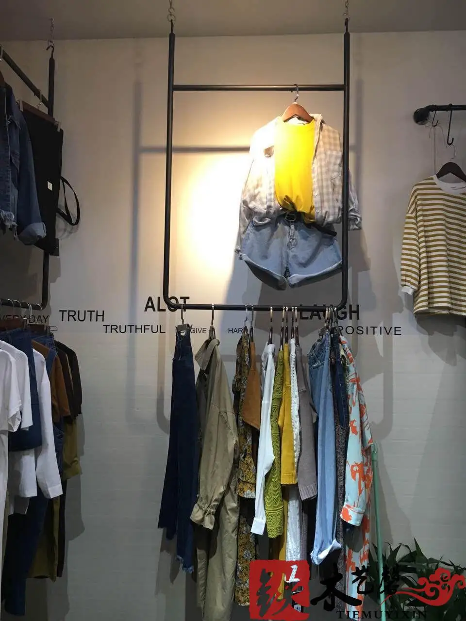 Black and white clothes hanging gantry. Clothing display shelf, display stand, ceiling hangs clothes hangers